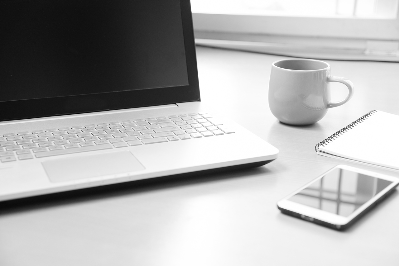 laptop comuter on top of a white desk